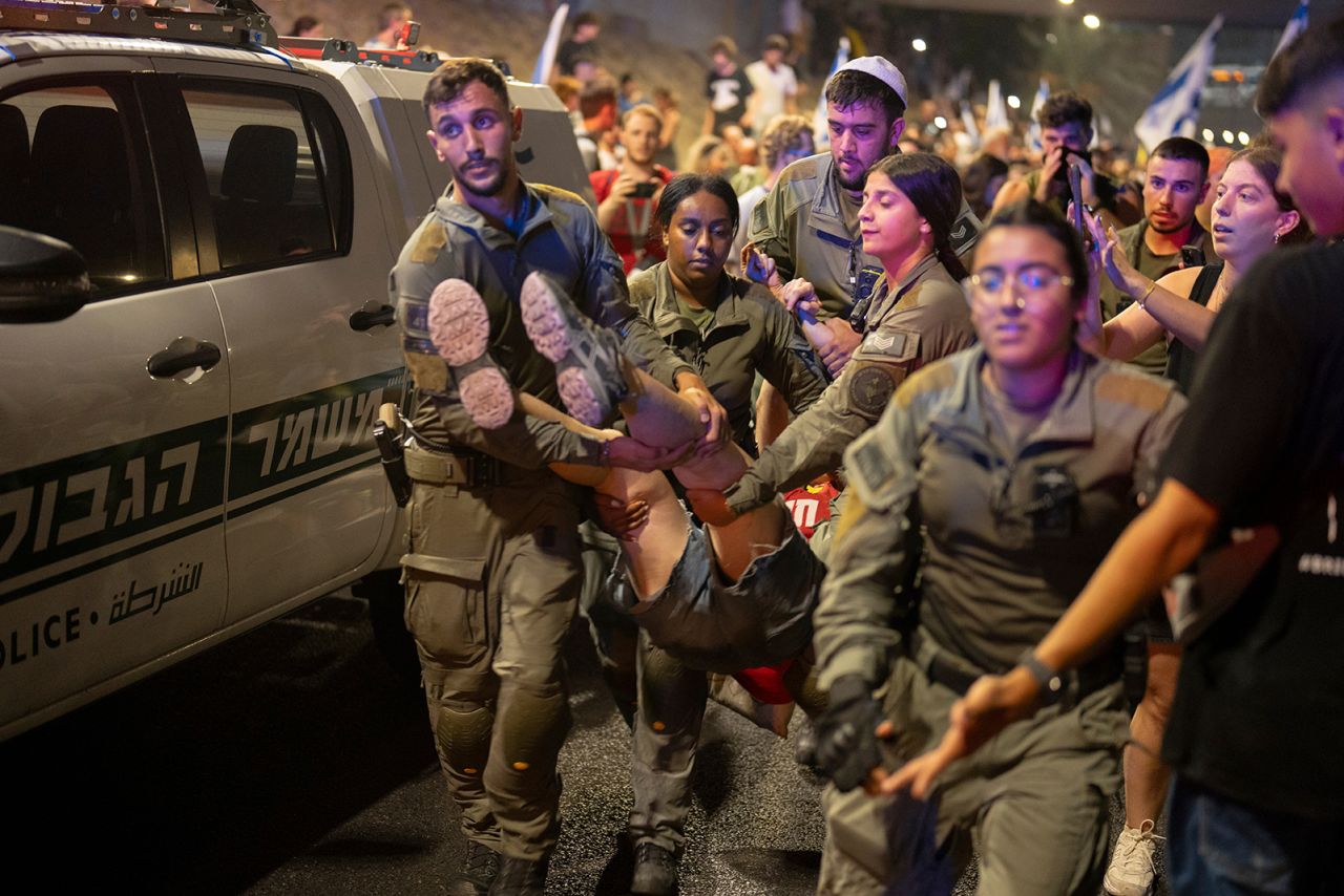 Police officers arrest a protester in Tel Aviv, Israel on September 1.