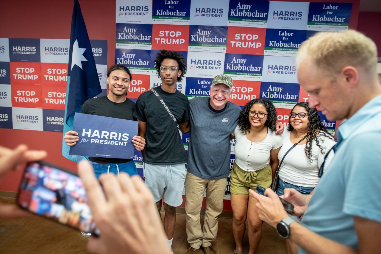 Walz poses with people in St. Paul at a canvassing event for the Democratic presidential ticket in July 2024. Walz had been an outspoken defender of Biden. But when the president dropped out, Walz endorsed Kamala Harris the next day and has since emerged as a reliable, energetic and cutting advocate for the Democratic nominee.