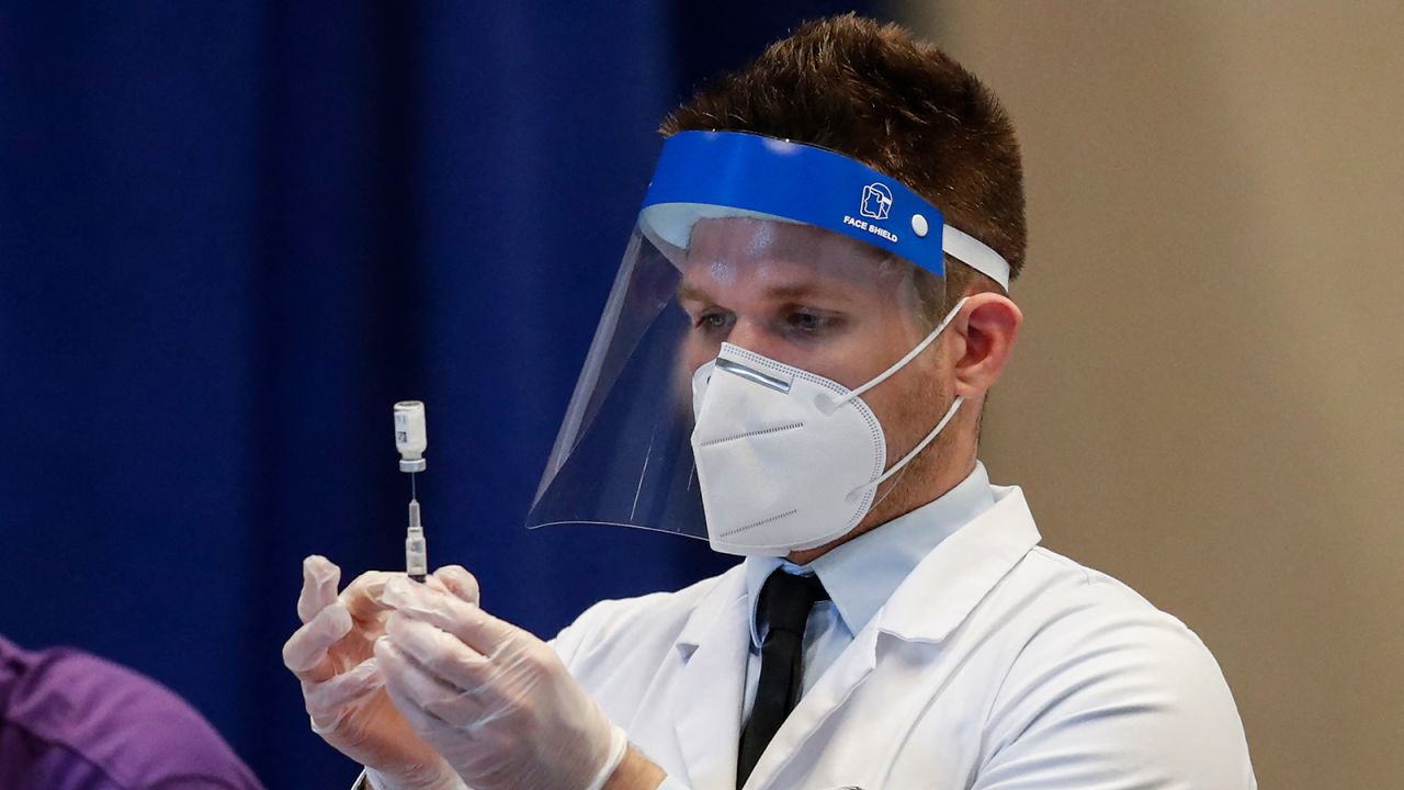 A medical worker prepares a syringe with a dose of the Johnson & Johnson Covid-19 vaccine at the International Union of Operating Engineers Local 399 union hall vaccination site in Chicago, Illinois, on April 6.