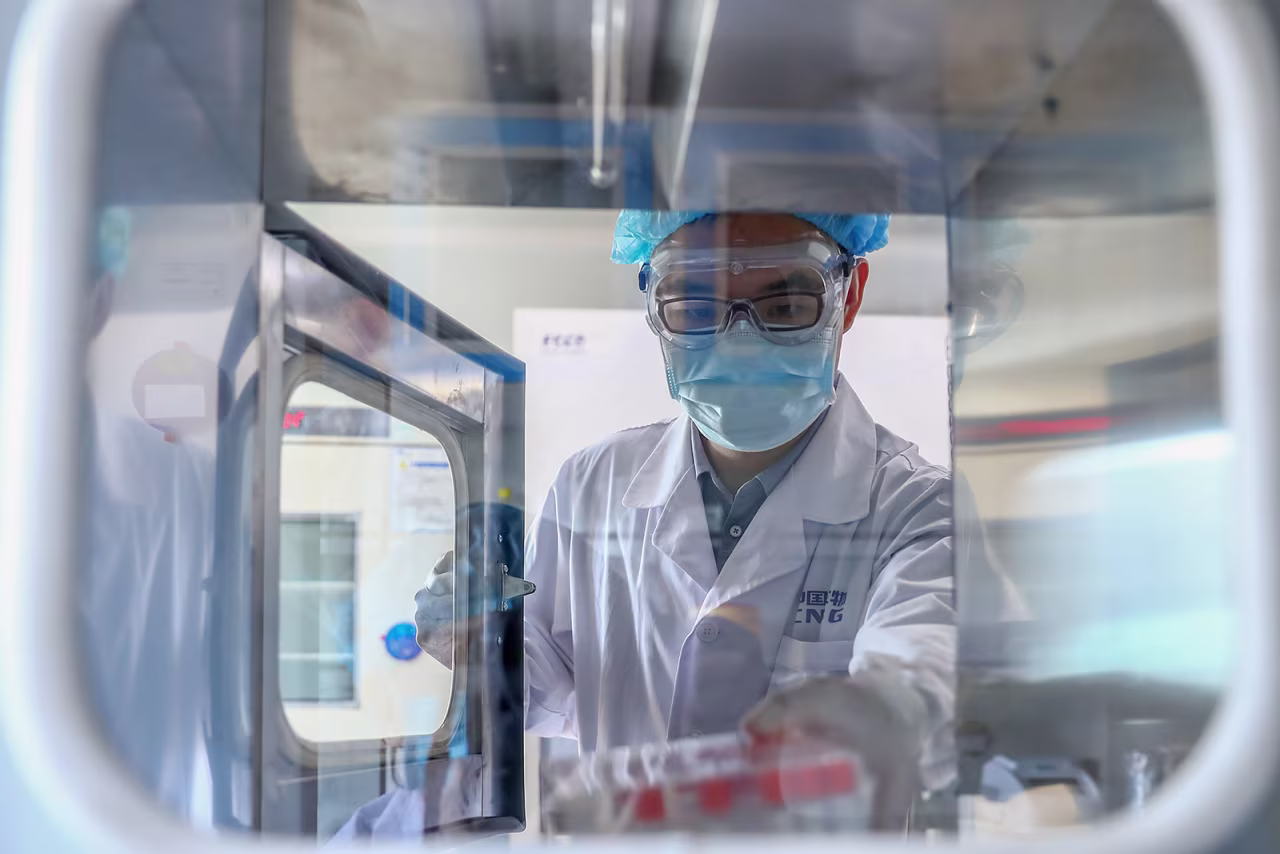 A staff member takes out samples of the Covid-19 inactivated vaccine at a vaccine production plant of China National Pharmaceutical Group Sinopharm, in Beijing, on April 11.