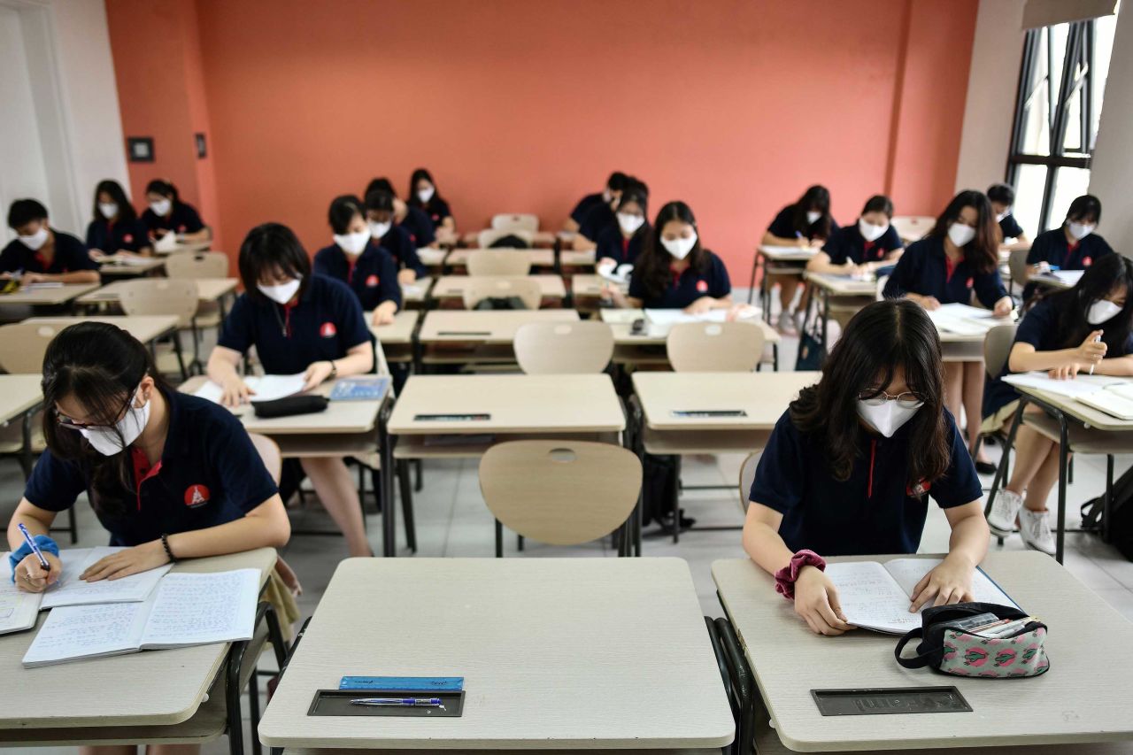 Students wearing face masks sit inside a classroom at the Marie Curie school in Hanoi, Vietnam, on May 4, as schools reopened.