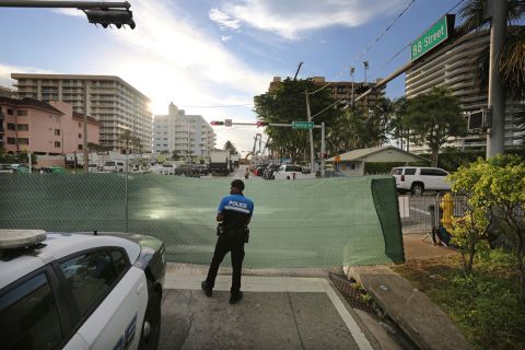 A police officer stands guard at the intersection of 88th Street and Harding Avenue near the Champlain Towers South Condo in Surfside, Miami on June 28.