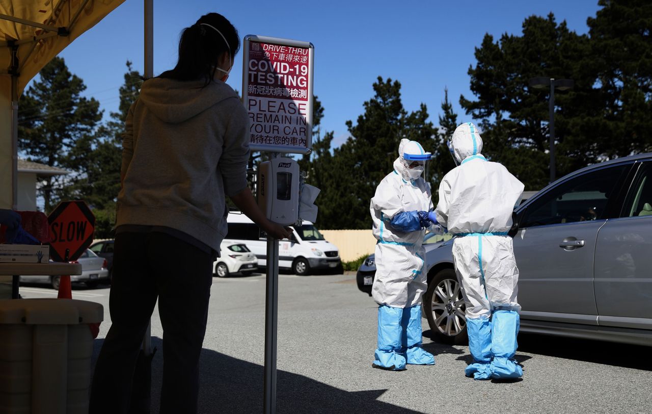 Medical professionals administer coronavirus tests at a drive-thru testing station in Daly City, California on March 26.