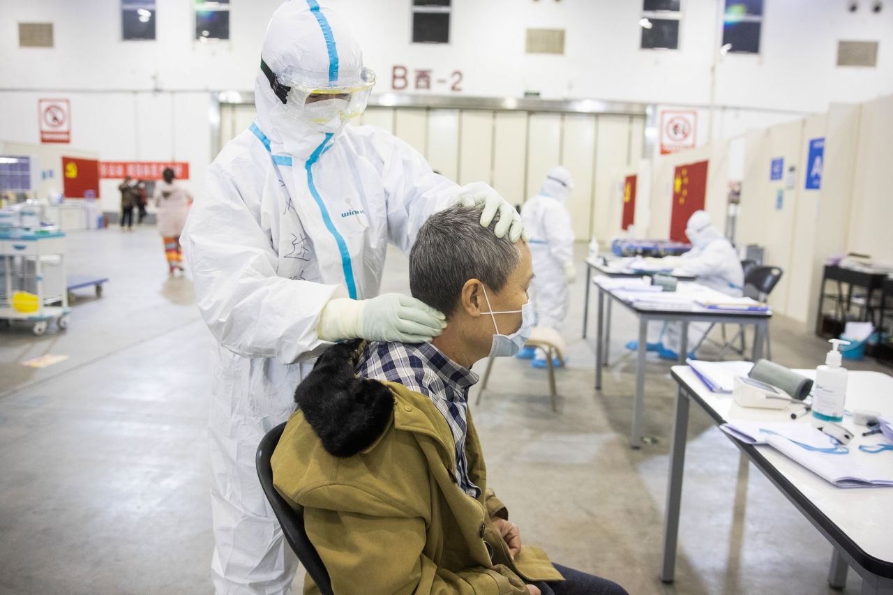 A member of the medical staff massages a patient at the converted hospital.