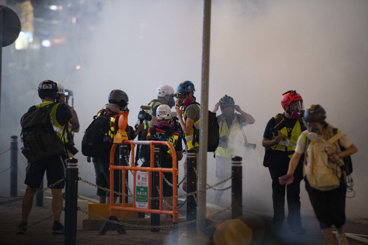 Members of the press seen among the tear gas Sunday night.