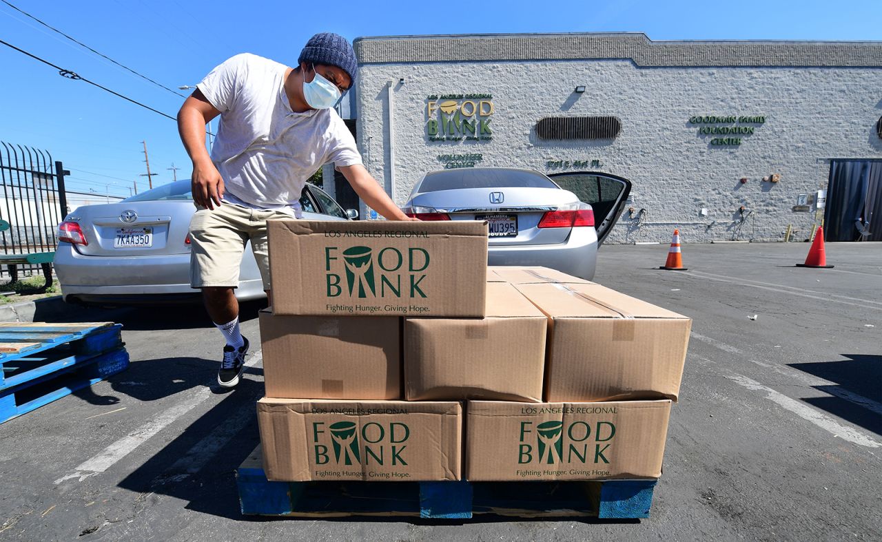 People load their vehicles with boxes of food at a Los Angeles Regional Food Bank on May 5, in Los Angeles, California. Food Banks across the United States are seeing numbers and people they have never seen before amid unprecedented unemployment.