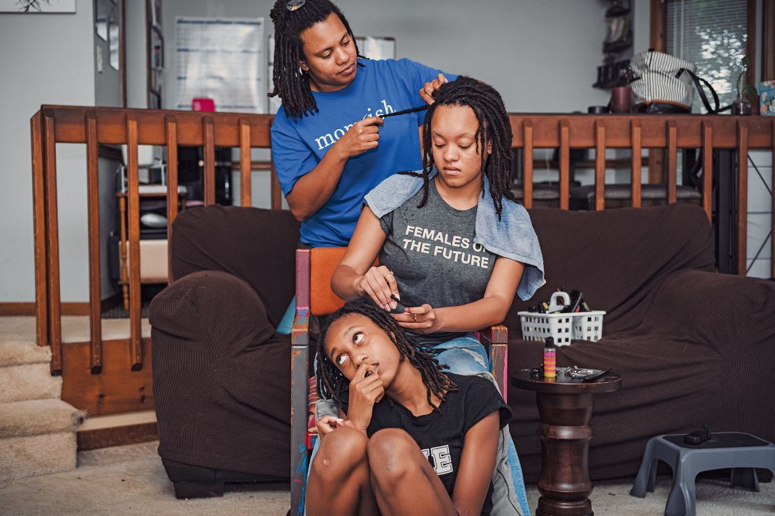 All three of Tonya's children — pictured here, Tonya with her daughters Briana and Grace — wear their hair in braids and locs.