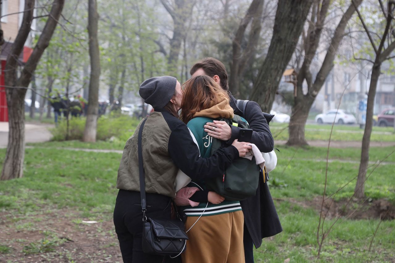 People react as they leave a multi-store building in Odesa after Russian troops strike, on Saturday, April 23.
