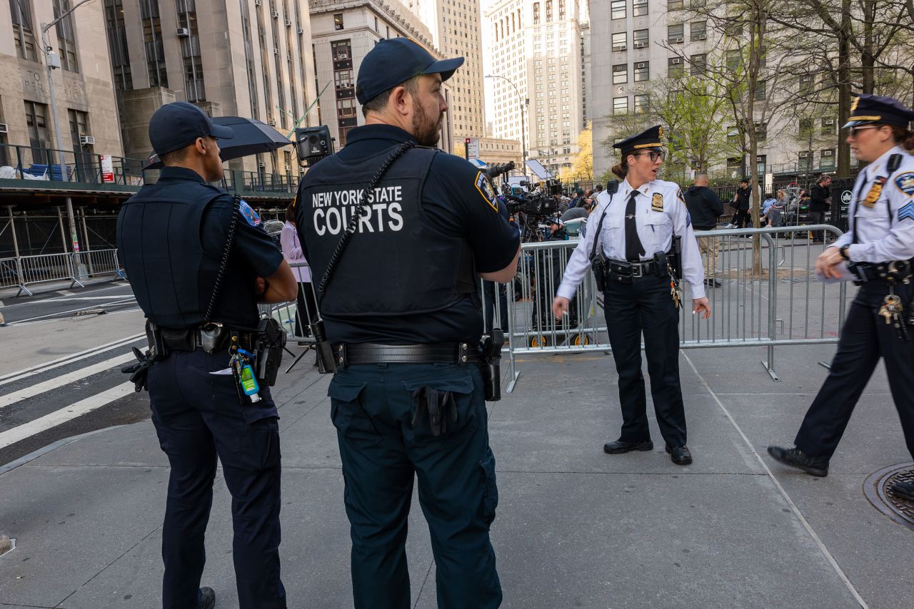 Law enforcement officers stand outside of Manhattan Criminal Court in New York on April 15.