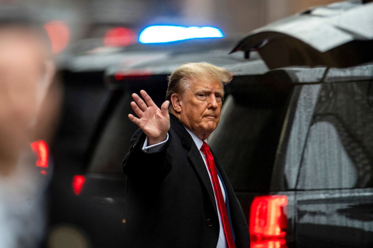 Donald Trump waves as he departs for court in New York, on January 26. 