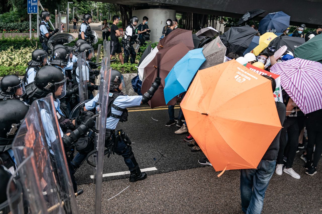 Police officers and pro-democracy protesters clash outside government headquarters.