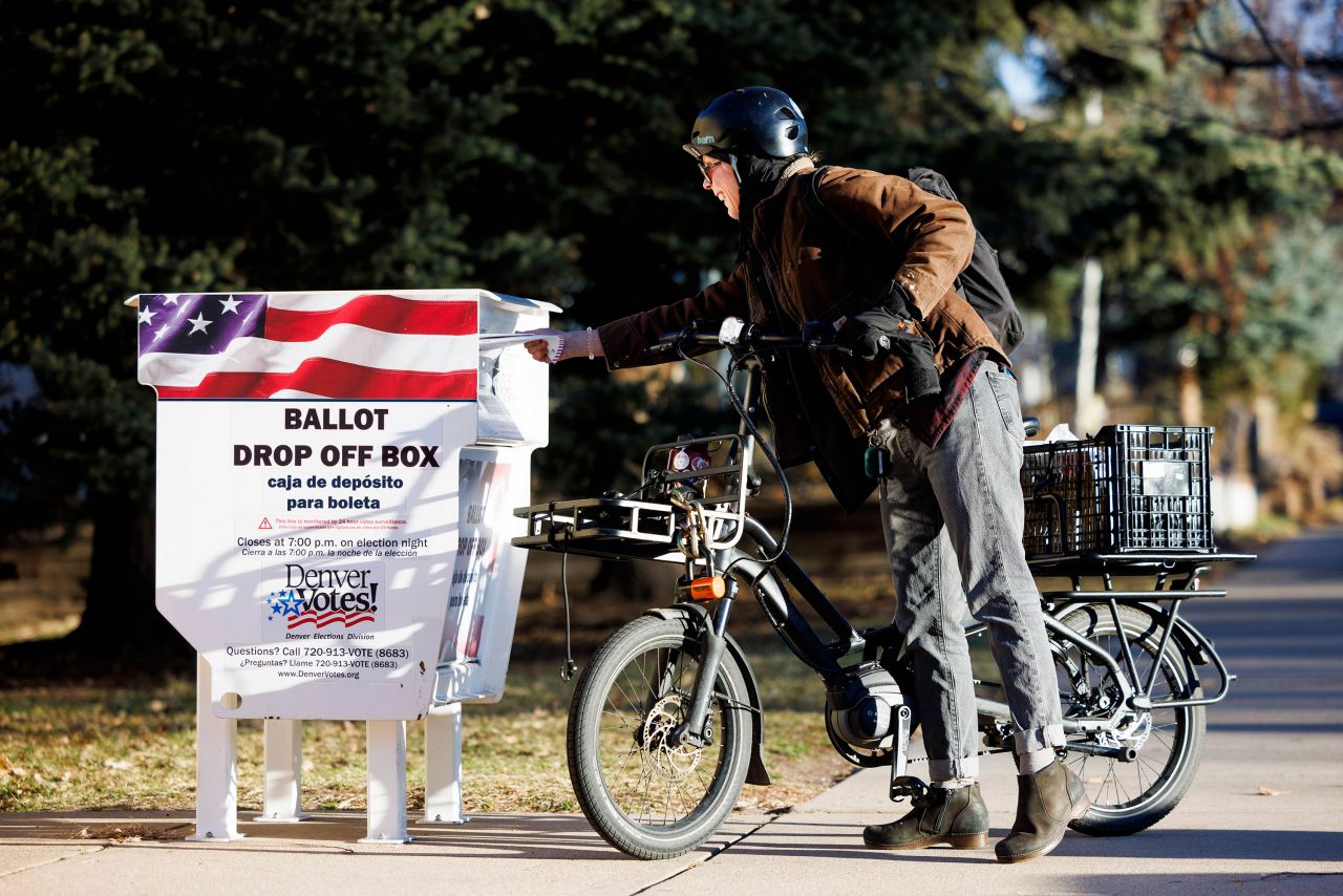 A voter submits their ballot at a dropoff box in Denver, Colorado, on Tuesday.