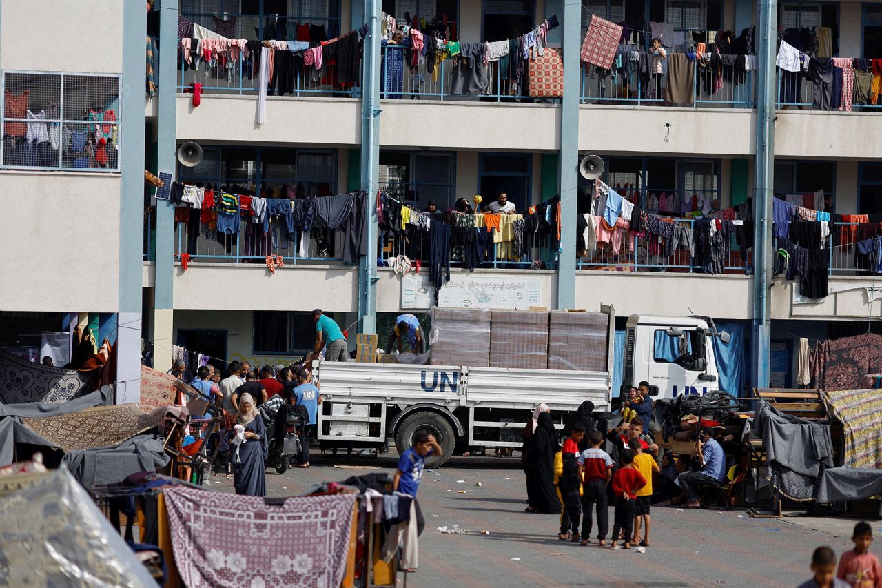 Palestinians take shelter in a UN-run school and receive aid distributed by the United Nations, in Khan Younis, Gaza, on October 23.