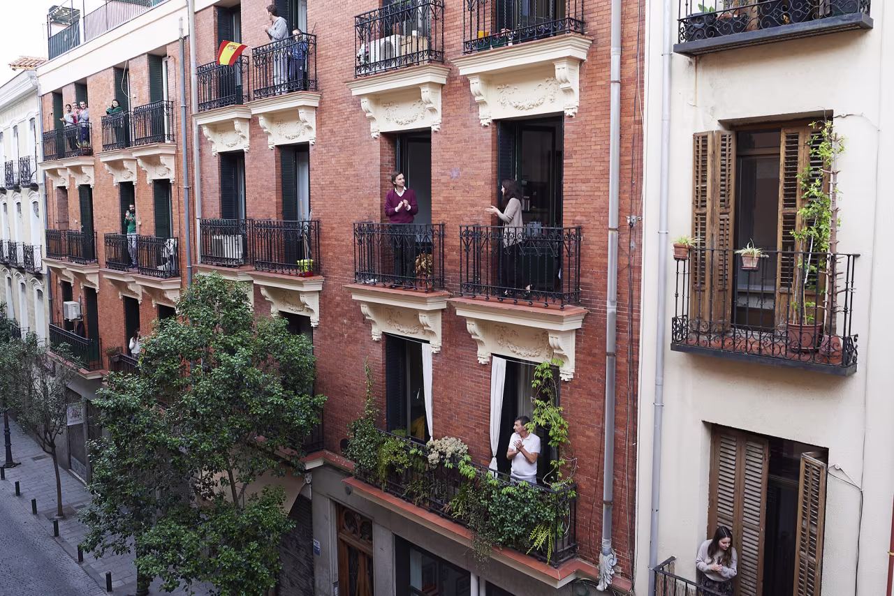 People on their balconies applaud to pay tribute to healthcare workers struggling to fight the coronavirus pandemic on Saturday, April 18, in Madrid.