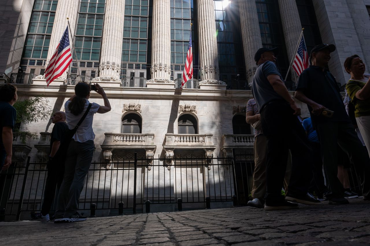 People walk through the Financial District near the New York Stock Exchange on July 11.