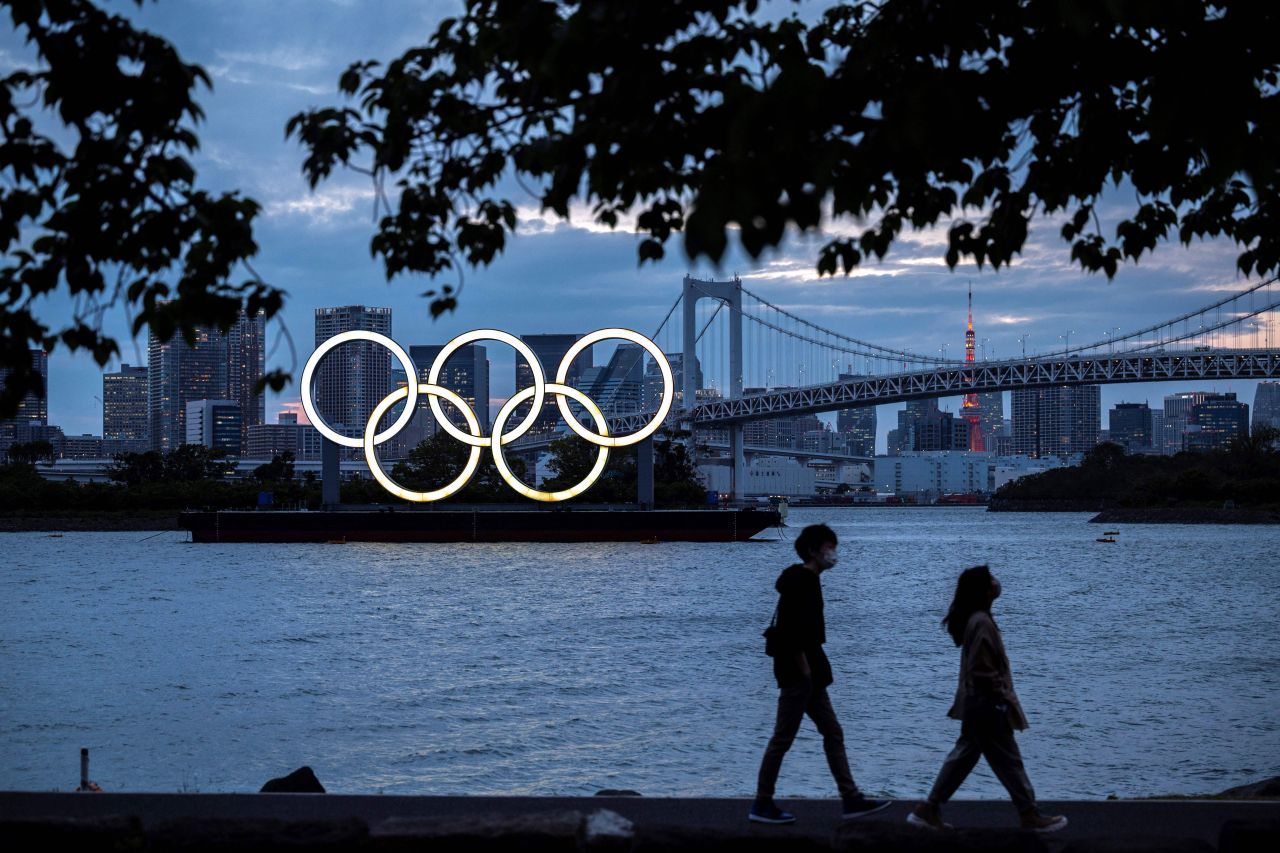 The Olympic rings are lit up at dusk on the Odaiba waterfront in Tokyo on April 28.