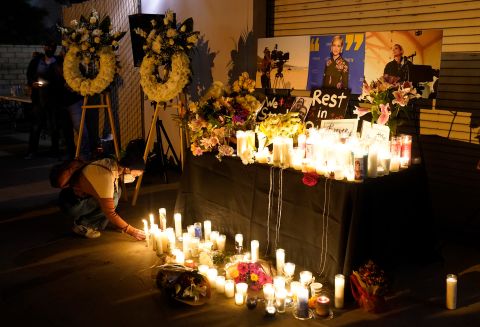 A woman lays down a candle during a vigil for cinematographer Halyna Hutchins, on Sunday, October 24, in Burbank, California. 