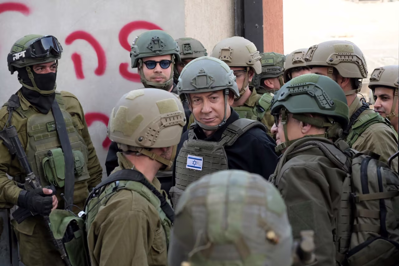 Israeli Prime Minister Benjamin Netanyahu, center, receives a security briefing with commanders and soldiers in the Gaza Strip on Monday.