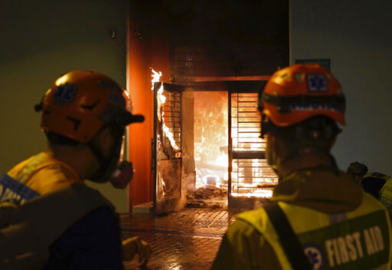 First aid volunteers try to extinguish a fire set by local residents in Fanling on Sunday. 