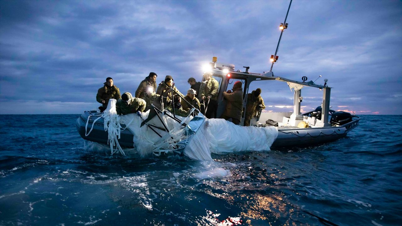 In this image provided by the US Navy, sailors assigned to Explosive Ordnance Disposal Group 2 recover a high-altitude surveillance balloon off the coast of Myrtle Beach, South Carolina, on February 5.
