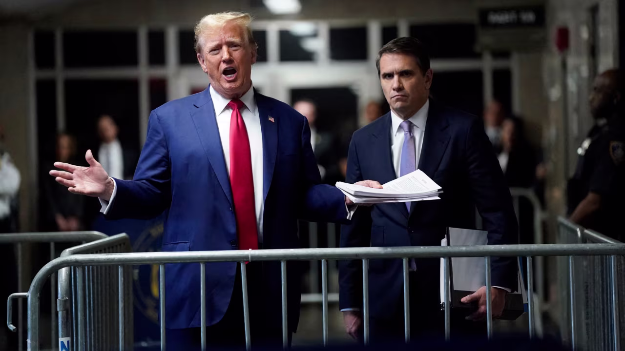 Former President Donald Trump, with attorney Todd Blanche, speaks to the press before leaving for the day Friday.
