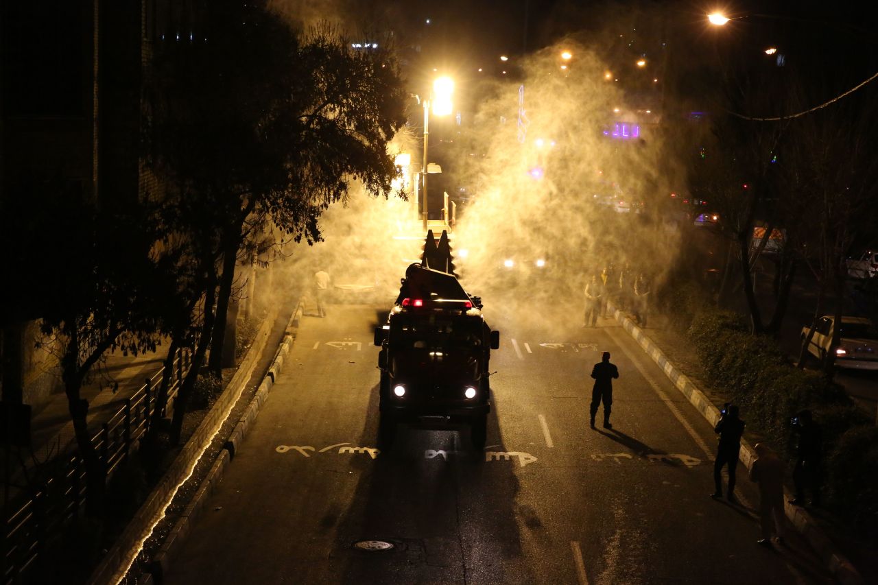 Iranian firefighters disinfect streets and alleys in southern Tehran to halt the spread of coronavirus on March 11.