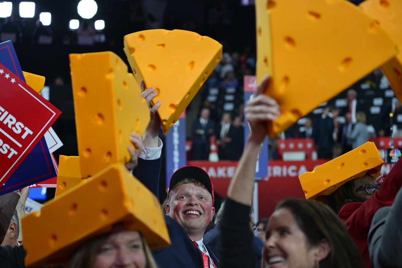 Delegates hold up cheese hats — a Wisconsin tradition — at the convention.