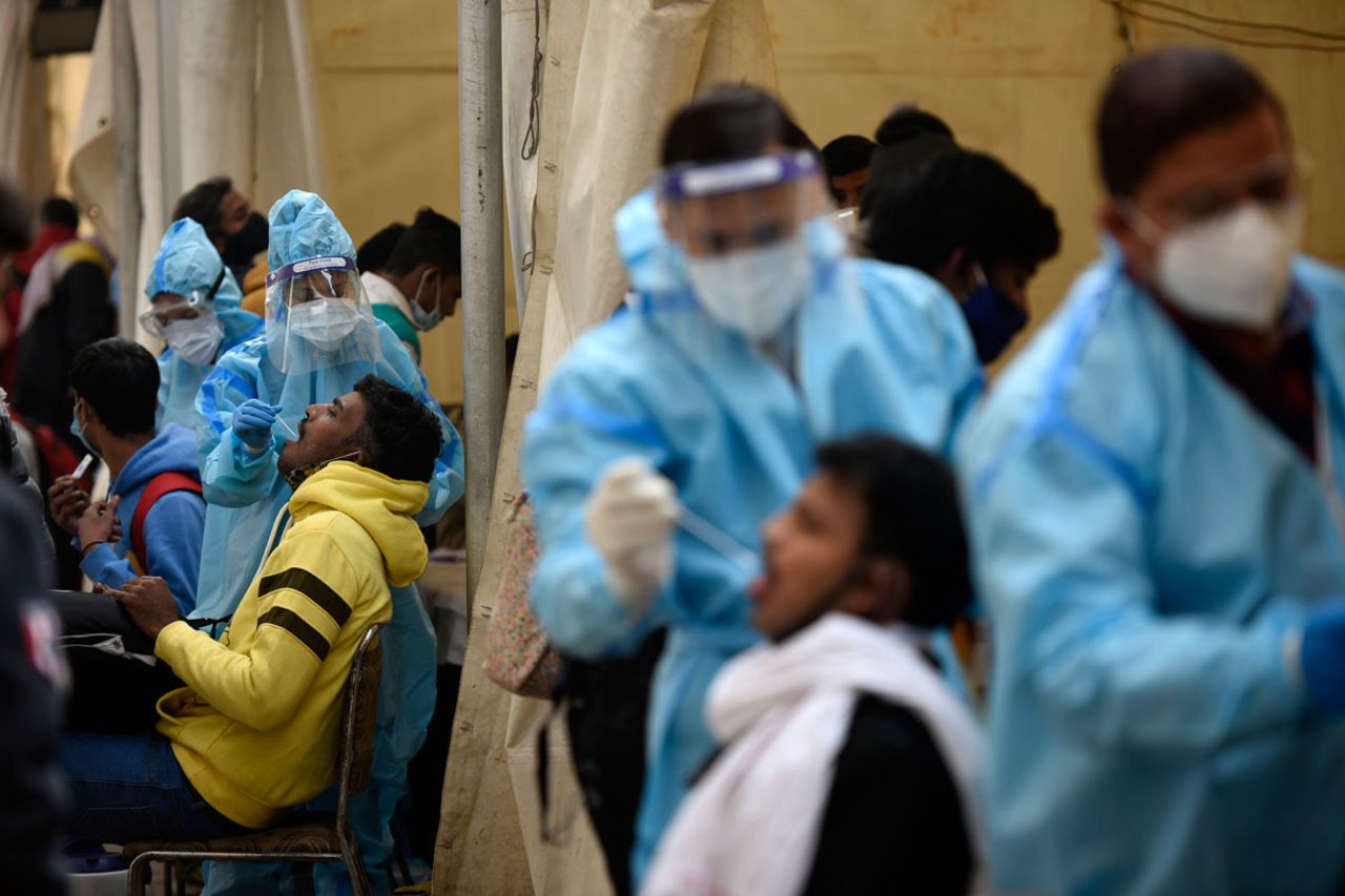 Incoming travelers are screened for the coronavirus at Anand Vihar Inter State Bus Terminal on December 27 in New Delhi, India.