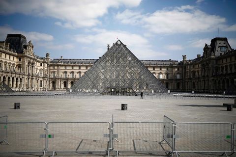 A security officer guards the main entrance of the Louvre Museum in Paris on  April 2, in Paris. 