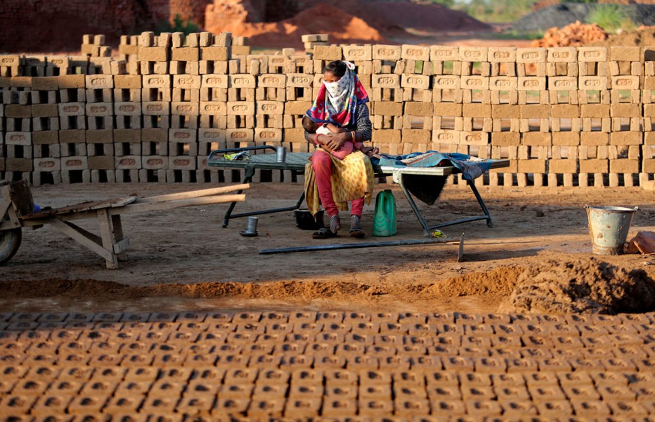 An laborer feeds her child at a brick kiln on the outskirts of Jammu, India, on Wednesday, April 22.