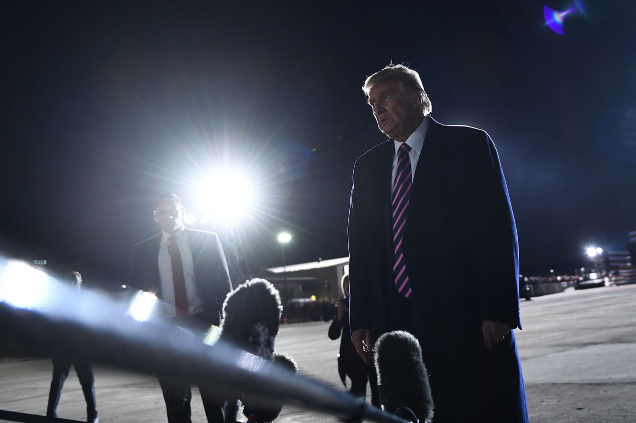 President Donald Trump reacts to the news of the death of Supreme Court Justice Ruth Bader Ginsburg on the tarmac of Bemidji Regional Airport after addressing supporters during a "Great American Comeback" rally at in Bemidji, Minnesota, on September 18.