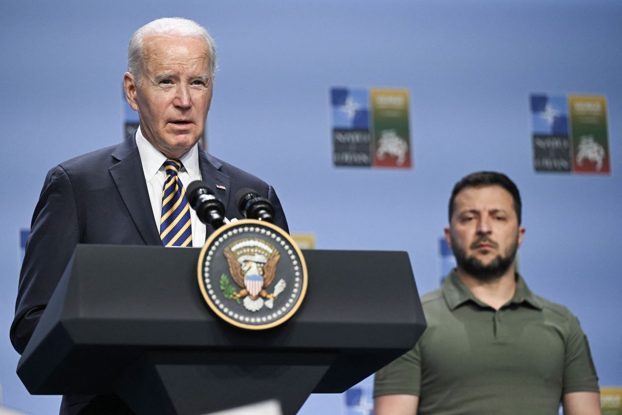 US President Joe Biden speaks during the NATO Summit in Vilnius, Lithuania, on July 12, as Ukrainian President Volodymyr Zelensky looks on. 