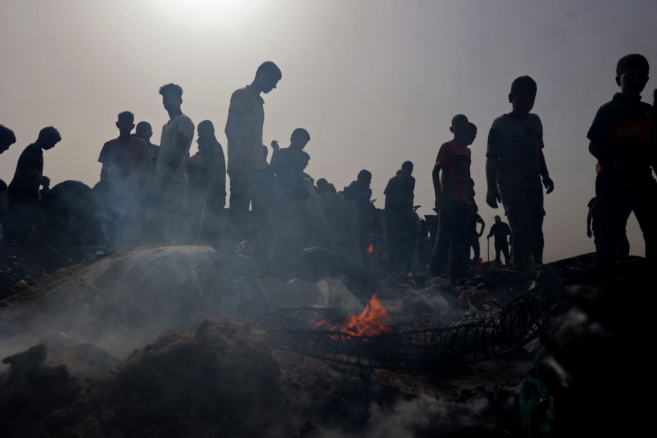 Palestinians gather at the site of an Israeli strike on a camp for internally displaced people in Rafah on Monday.