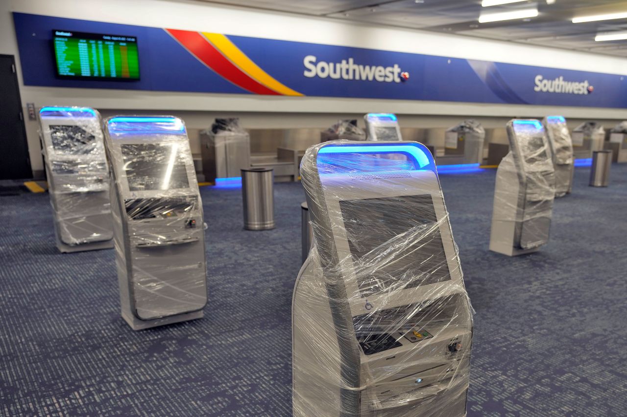 Kiosks at the Southwest Airlines ticket counter are covered in protective wrapping at the Tampa International Airport on Tuesday. The airport closed to all air travel early Tuesday.