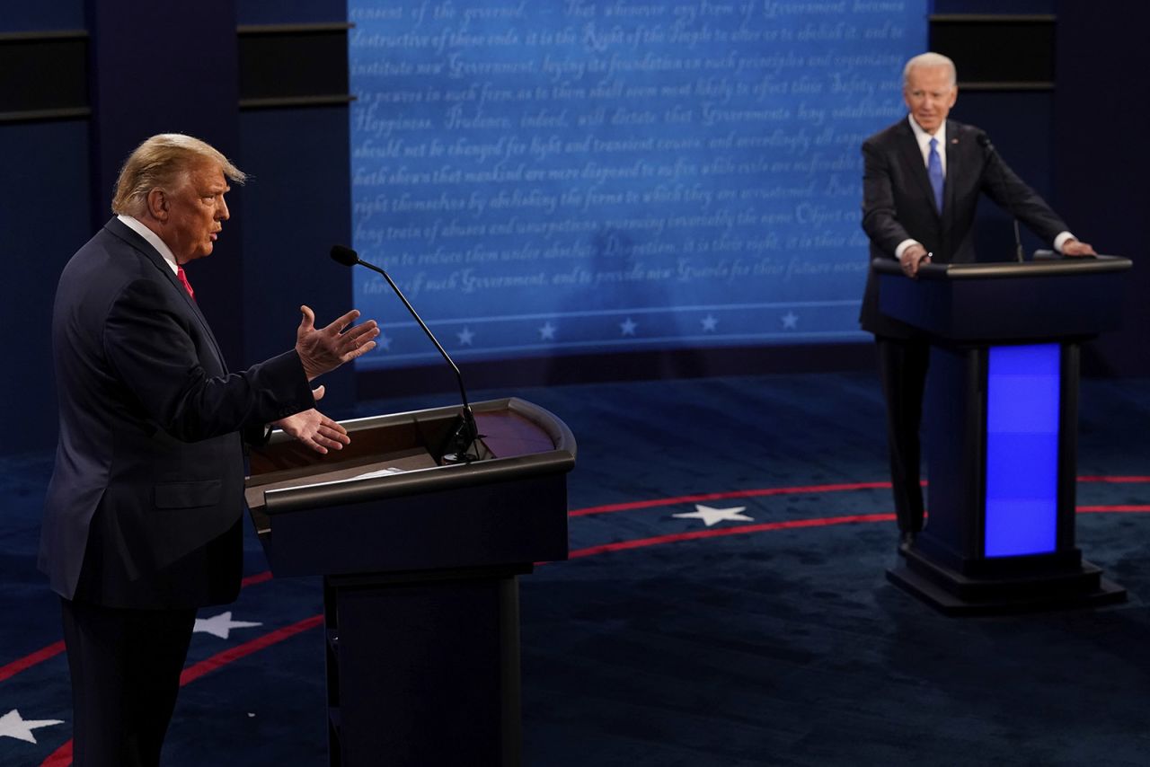 President Donald Trump answers a question as Democratic presidential candidate former Vice President Joe Biden listens during the second and final presidential debate on Thursday in Nashville. 