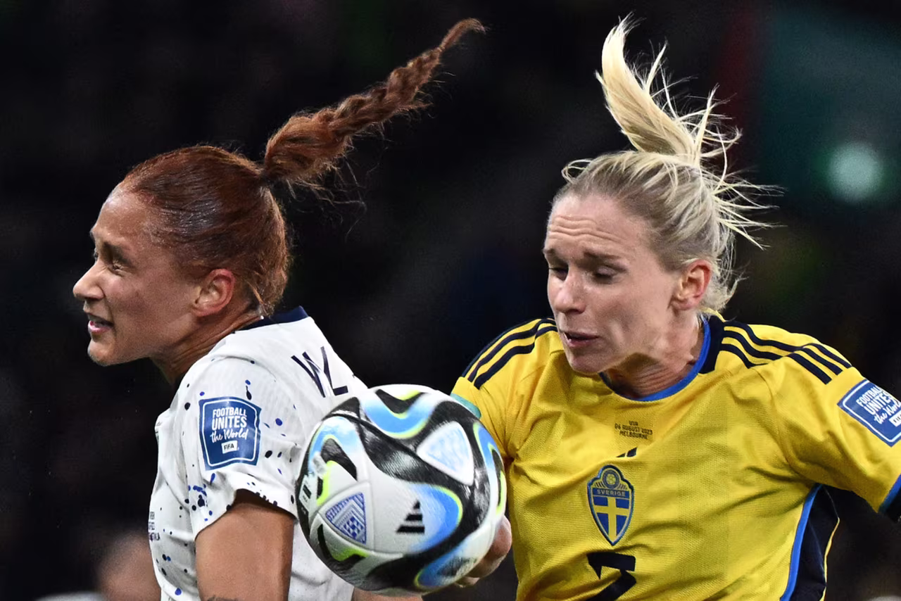 US forward Lynn Williams, left, and Sweden defender Jonna Andersson, right, fight for the ball.