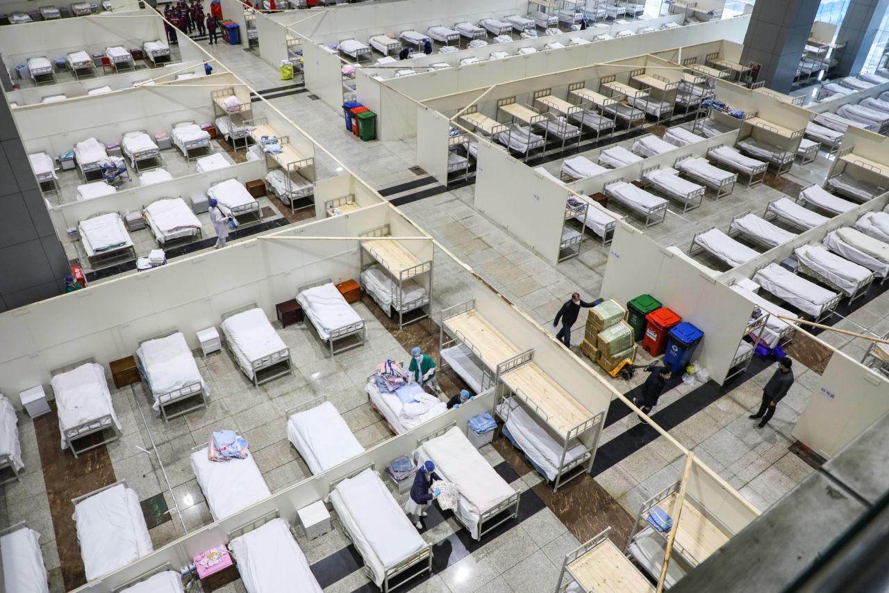 Medical staff preparing beds for patients at a converted hospital in Wuhan on Wednesday.