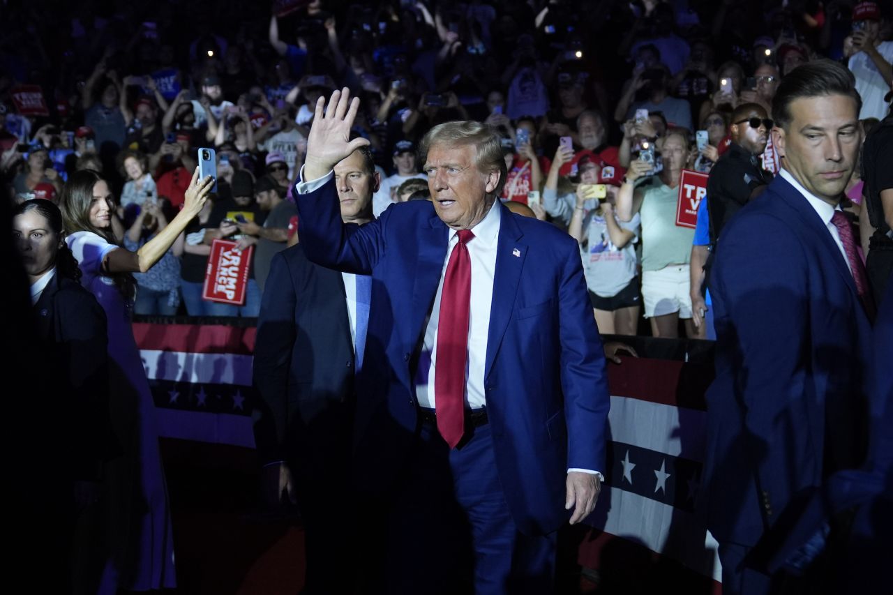 Former President Donald Trump waves to supporters as he is introduced for a town hall event in Flint, Michigan, on Tuesday.