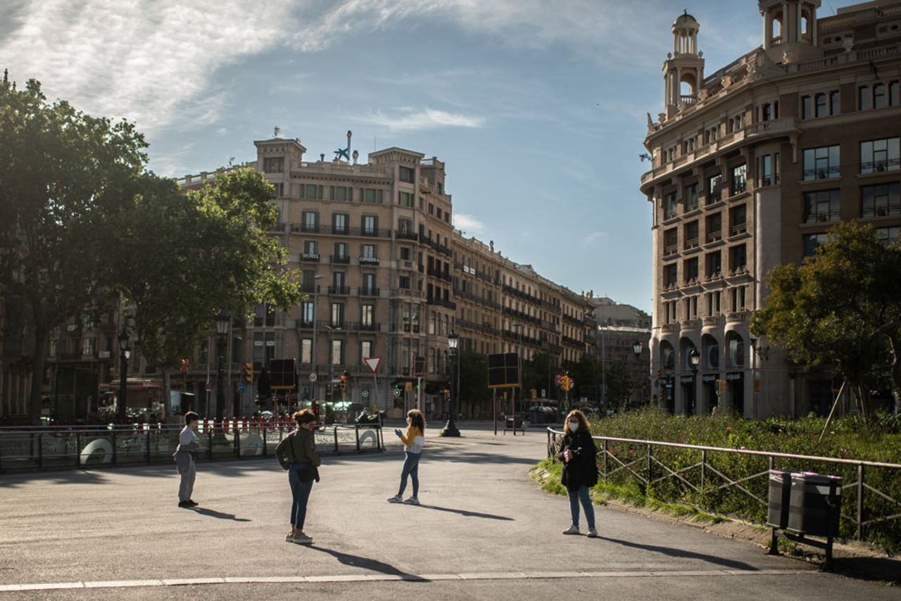 Members of the public meet to talk on the street observing social distancing measures on April 29 in Barcelona, Spain.?