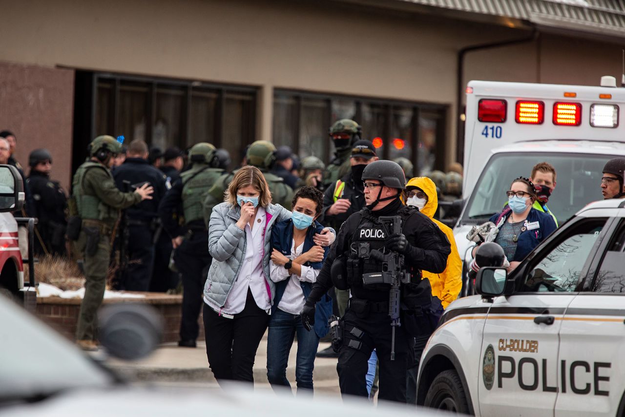 People walk out of a King Soopers grocery store in Boulder, Colorado, after a shooting there on Monday, March 22.