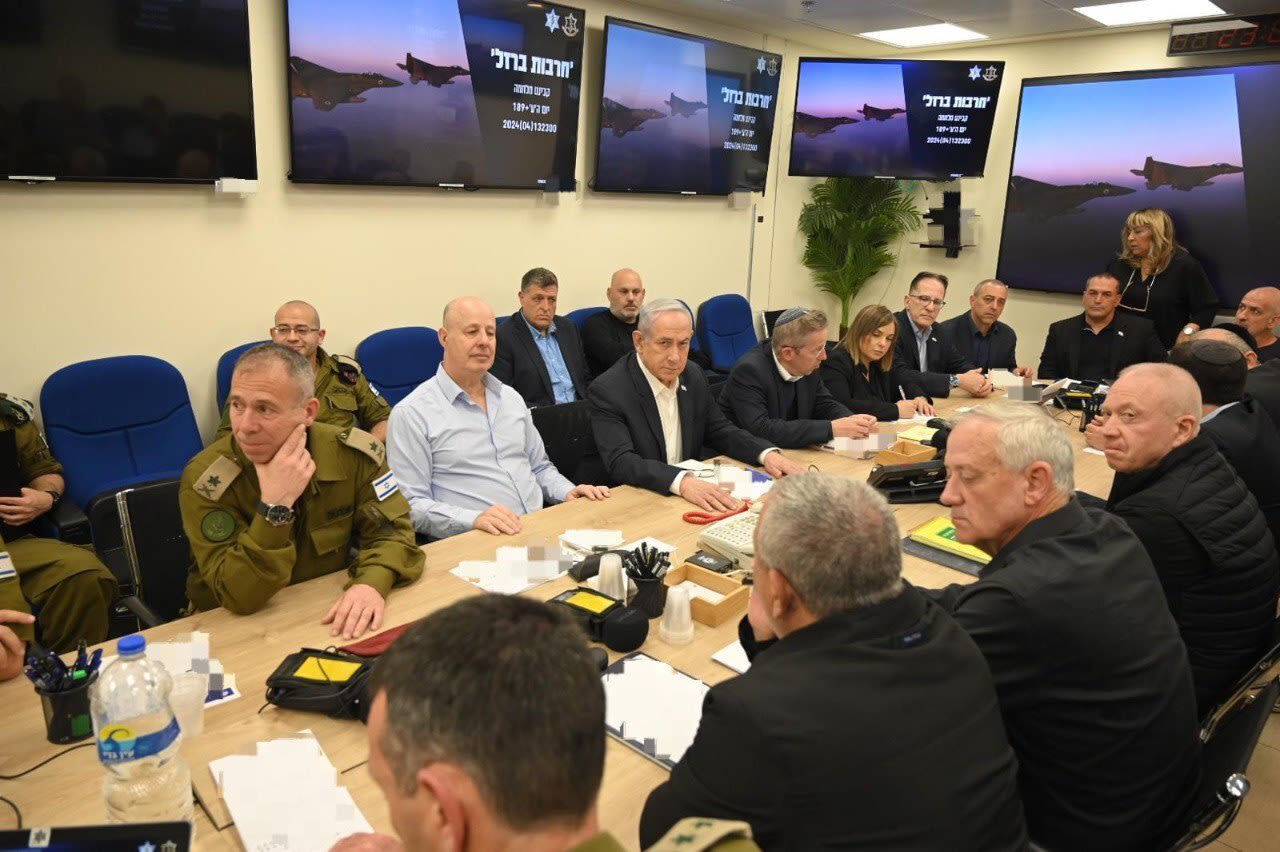 This handout photo shows the Israeli war cabinet, chaired by Prime Minister Benjamin Netanyahu, center, holding a meeting in Tel Aviv, Israel, on April 14. Portions of this photo have been blurred by the source.