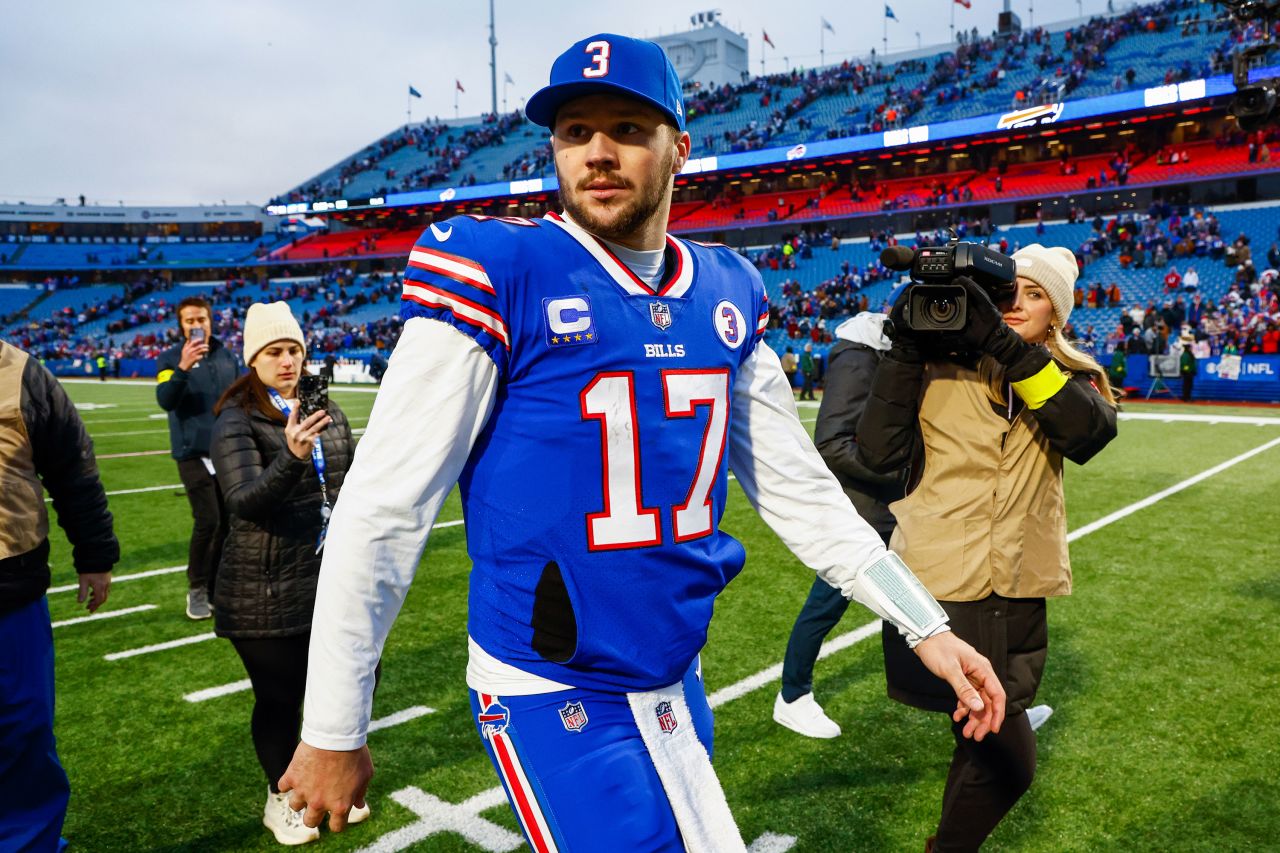 Josh Allen walks off the field after defeating the New England Patriots on Sunday.