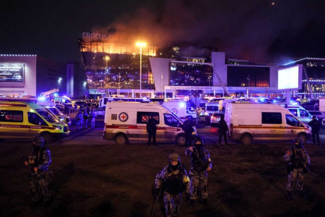 Law enforcement officers are seen deployed outside the burning Crocus City Hall concert hall in Krasnogorsk, outside Moscow, on March 22.