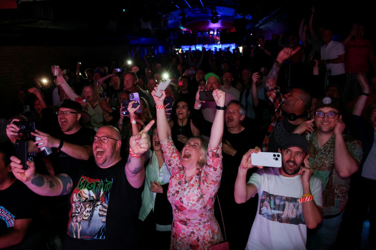 People celebrate exit poll results at a Stop The Tories election afterparty in London, on July 4. 