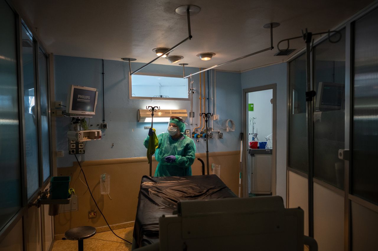 A cleaning staff member disinfects a room after a Covid-19 patient died in the ICU of the Hospital Universitari de Bellvitge near Barcelona, Spain, on April 9.