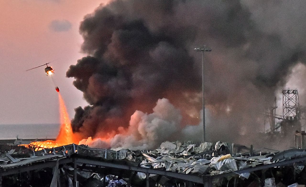 A helicopter fights a fire at the scene of an explosion on August 4.