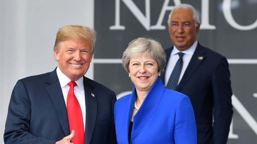 US President Donald Trump (L) gestures as he poses alongside Britain's Prime Minister Theresa May (R) as Portugal's Prime Minister Antonio Costa (TOP) looks on during the opening ceremony of the NATO in Brussels on July 11, 2018