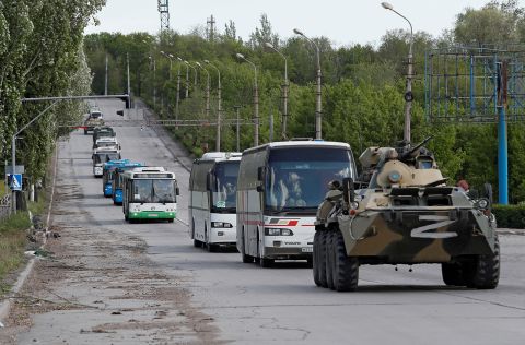 Buses carrying service members of Ukrainian forces who spent weeks holed up at the Azovstal plant drive away under escort of the pro-Russian military in Mariupol, Ukraine, on May 17.