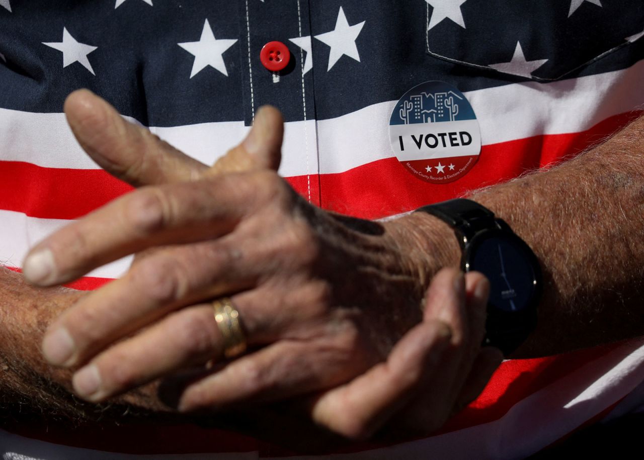 A man talks with others about their frustration about alleged problems casting their voting ballot in Wickenburg, Arizona, on Tuesday. 