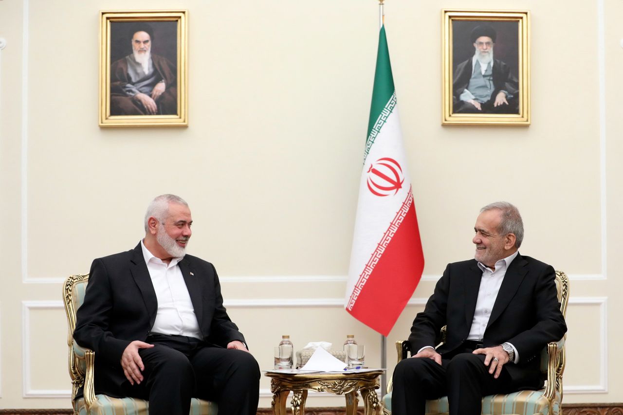 In this photo released by the Iranian Presidency Office, President Masoud Pezeshkian, right, meets Hamas chief Ismail Haniyeh, at the President's office in Tehran, Iran, on July 30.